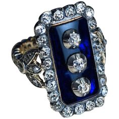 This impressive late 18th century, circa 1790, silver-topped gold ring is vertically set with a large cobalt blue glass plaque centered with three old cut diamonds set in silver cut down settings. The glass plaque is framed by 24 chunky old mine cut diamonds set in silver over gold. The trefoil-shaped shoulders of the ring are embellished with old mine cut diamonds. The shank is encrusted with old rose cut diamonds. The diamond-set shank and trefoils are later Victorian era replacements from the Antique Cushion Cut Diamond, Georgian Ring, Georgian Era, Diamond Cluster Engagement Ring, Platinum Diamond Engagement Rings, Faberge Eggs, Art Deco Engagement Ring, Art Deco Diamond, Unisex Ring