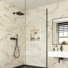 a bathroom with marble walls and flooring in white, beige and black colors is shown