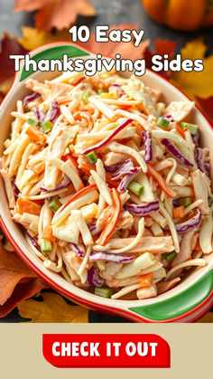 a bowl filled with coleslaw sitting on top of a table next to fall leaves