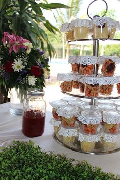 a tiered tray with cupcakes and muffins on it