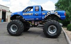 a blue monster truck parked in a parking lot