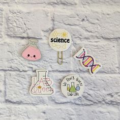 four magnets on a brick wall that say science