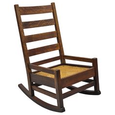 a wooden rocking chair with wicker seat and back cushion on an isolated white background