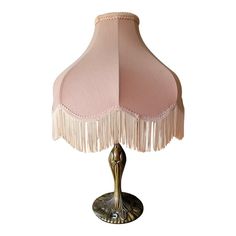 a pink lamp with tassels on it