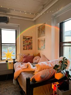 a bed room with a large window and a rainbow in the sky