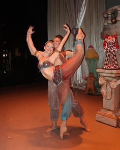 two women in belly dance pose on stage