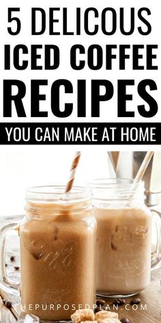 two mason jars filled with iced coffee on top of a wooden table