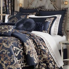 a bed covered in blue and gold comforters