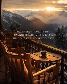 a wooden chair sitting on top of a balcony next to a table with a cup