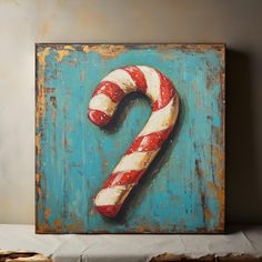 a painting of a candy cane on a blue background