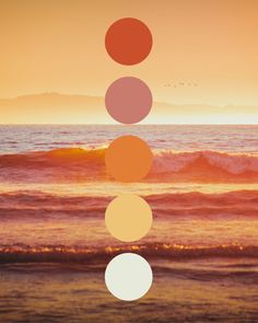 the sun is setting over the ocean and there are five circles