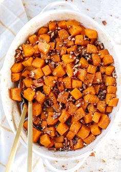 a white bowl filled with cooked sweet potatoes