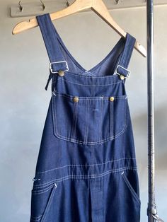 Vintage 1970s Sears Dark Wash Denim Overalls. Dark blue denim made from what feels to be cotton fibers. Snap closures on chest pocket. Adjustable shoulder straps with a button fly crotch closure. Denim is super soft and nice and broke in. Condition overall is good with minor flaws that include; a couple pinholes on left leg and a small tear/snag on back of shoulder as shown in photos. Please see all photos for details. Refer to measurements below to ensure a proper fit. Best fits a modern S-M 17" across waist 13.5" shoulder to shoulder (approx.) 21" across hip 29" inseam Dark Blue Denim, Denim Overalls, Des Moines, Dark Wash Denim, Vintage 1970s, Chest Pocket, Cotton Fiber, Shoulder Straps, Blue Denim