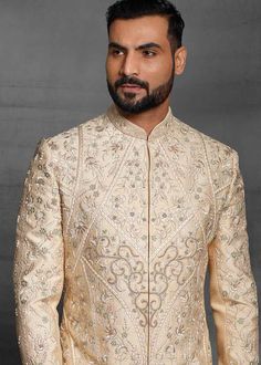 Designer Ivory Wedding Indian Sherwani With Kurta Chudidaar
Designer custom made ivory fully embroidered sherwani with chudidar . The latest heavy silk embroidered sherwani is best choice for reception wear . It is suited for Indian and Pakistani wedding wear . 
One of the standout features of this sherwani is the intricate embroidery adorning its surface. Our skilled artisans have meticulously handcrafted every detail, using fine threads and intricate patterns that showcase traditional Indian craftsmanship at its best. The embroidery showcases a harmonious blend of motifs, ranging from floral designs to intricate geometric patterns, creating a visually stunning ensemble that captures attention and admiration . Please note there can be slightly difference between the image and the produc Indian Sherwani, Indian Wedding Clothes For Men, Silk Churidar, Resham Embroidery, Wedding Sherwani