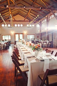 a large dining room with tables and chairs set up for an event or function,