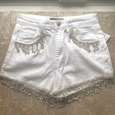 White Jean Denim Shorts With Rhinestone Fringe. New With Tags Size Small Summer Party Jeans With Rhinestones, Summer Party Embellished Jeans, Fitted Summer Jeans With Rhinestones, Summer Fitted Jeans With Rhinestones, Fitted Rhinestone Jeans For Summer, White Rhinestone Bottoms For Summer, Summer Embellished Cotton Jeans, Embellished White Bottoms For Summer, White Embellished Bottoms For Summer