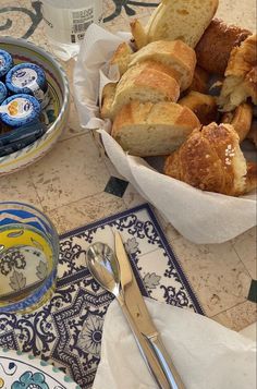 a table topped with plates and bowls filled with pastries