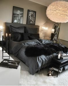 a black and white bedroom with fur rugs on the floor