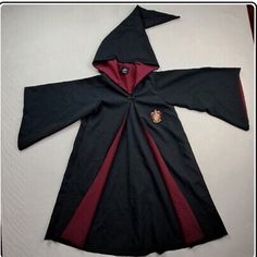 a harry potter robe is laying on the floor with it's hood pulled up