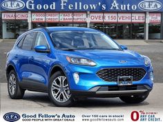 a blue ford suv is parked in front of a dealership with the words good fellow's auto written on it