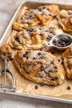 several pastries on a baking sheet with chocolate chips