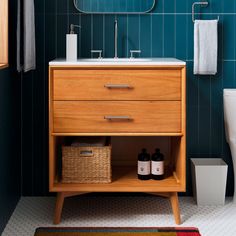 a bathroom with a sink, toilet and towel rack