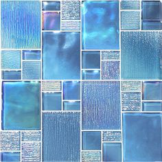 blue glass mosaic tiles are arranged in an abstract pattern, with metallic foil on the edges