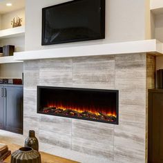 a modern fireplace in the middle of a living room with a flat screen tv above it