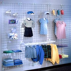 a display case with clothes hanging on the wall