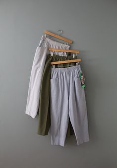 "Vintage essential high waisted minimalist baggy trousers in soft cotton blend material. Elastic waist and two large hip pockets. Comes in seersucker stripe, moss green and periwinkle blue colors. (Choose from the option below) Circa: 1990's Fits like medium (vintage size 12 petite): 30\" waist 40\" hips 37\" length 12\" rise 25\" inseam In excellent condition! (New Old Stock with tags attached)" Relaxed Fit Bottoms With Pockets For Daywear, Relaxed Fit High Waist Bottoms For Daywear, Relaxed Fit High-waisted Pants, Oversized High Waist Bottoms With Pockets, Oversized High-waist Bottoms With Pockets, Oversized High-waisted Work Pants, Daywear Trousers With Side Pockets, Tapered Leg Bottoms With Pockets For Daywear, Casual Oversized Bottoms For Daywear