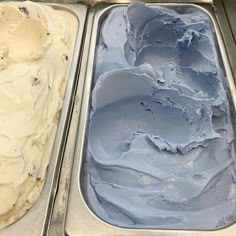 two pans filled with ice cream sitting on top of a counter next to each other