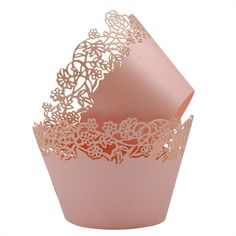 pink cupcake wrappers with laser cut designs on the top and bottom, set against a white background