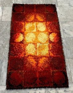 an orange and yellow rug on the floor