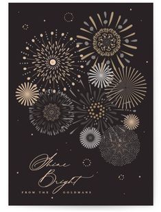 fireworks are lit up in the night sky with gold and silver foil on black paper