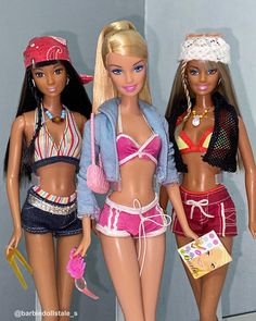 three barbie dolls standing next to each other