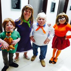 three children and an older woman posing for the camera