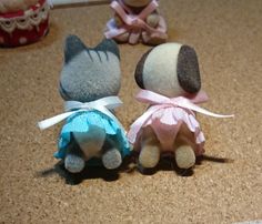 three small stuffed animals sitting on top of a counter