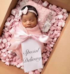 a baby is sleeping in a box with a sign on it that says special delivery