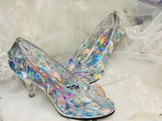 a pair of high heeled shoes with holographics on them