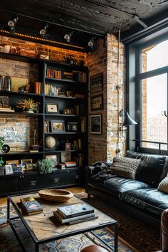 Rustic house interior design with exposed brick walls, a black bookshelf filled with books and decor, and a cozy seating area with a leather sofa. Large Blank Wall Ideas, Blank Wall Ideas, Large Blank Wall, Living Room Unique, Light Colored Furniture, Black Accent Walls, Room Unique, Accent Walls In Living Room, Living Room Loft