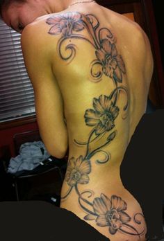 the back of a woman's body with flowers on it