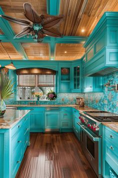 a blue kitchen with wood floors and ceiling fan in the center, along with turquoise cabinets