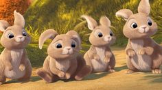 three little rabbits are sitting in the dirt