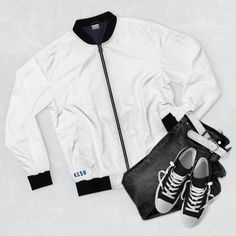 Elevate Your Style with this Classic White Bomber Jacket for Men! Make a bold fashion statement with the timeless and versatile White Bomber Jacket. Crafted with style and comfort in mind, this jacket is designed to elevate your everyday look and reflect your unique personality. The jacket features a stand-up collar that adds a touch of sophistication to your ensemble. The elastic cuffs and elasticized hem provide a snug fit, ensuring that you not only look stylish but also feel comfortable throughout the day. Embrace the classic bomber jacket look that never goes out of style. Two lined welt pockets at the front offer both practicality and visual interest, giving you a place to keep your essentials while enhancing the jacket's aesthetic appeal. The White Bomber Jacket is fully lined with Pilot Jacket, Print Jacket, Urban Fashion, Nike Jacket, Stand Up, Mens Jackets, Bomber Jacket, Athletic Jacket, Slim Fit