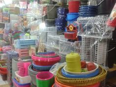 many different colored cups and bowls on display