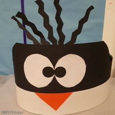 this is an image of a penguin made out of construction paper and cardboard with sticks sticking out of it