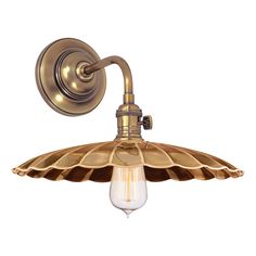 an antique brass wall light with a glass shade