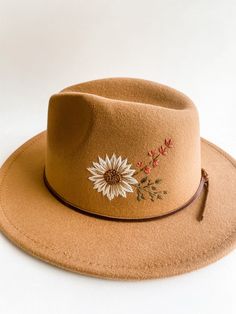 "Color: Tan Material: 65% Cotton, 35% Polyester Size: S-M | One size fits most women. Hat Circumference: 22-22.8\" (Comes with an adjustable string inside that can be tightened) Hat Height 4.33\" Brim Width 2.36\" A B O U T Hand embroidered wild flower scene Each hat has its own unique embroidered detail, no two are alike! Hat will come with handmade brown leather band and linen hat bag S H I P P I N G It will take 1-2 weeks to create this hat as it is stitched by hand. CUSTOM REQUESTS Custom re Linen Hat, Clothing Embroidery, Painted Hats, Beaded Hat, Beadwork Designs, Painted Bags, Women Hat, Felt Fedora, Hat Embroidery