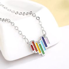 Introducing our enchanting rainbow heart necklace, a radiant emblem of love and diversity. Crafted with precision and care, this exquisite pendant boasts a delicate heart shape adorned with a captivating spectrum of colorful gemstones, evoking the spirit of unity and inclusion. The premium sterling silver composition ensures durability and everlasting shine, while the adjustable chain ensures a perfect fit for all. Whether worn as a symbol of love, support, or simply to brighten your day, this c Cheap Rainbow Heart-shaped Jewelry, Rainbow Heart Pendant Necklace, Necklace Barbie, Earrings Dangle Simple, Flower Daisy, Rainbow Jewelry, Rainbow Necklace, Engagement Band, Vintage Style Jewellery