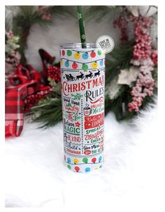 a christmas themed tumbler with the words merry written on it and a green straw